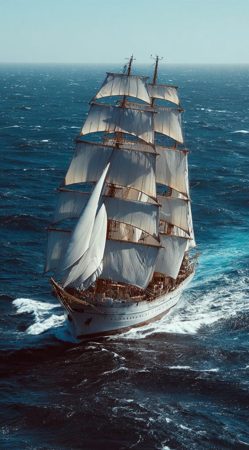 A majestic tall ship with full sails glides through the deep blue ocean, leaving a trail of white foam in its wake.