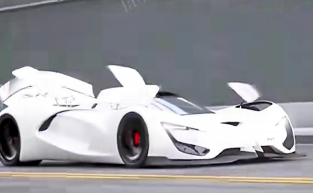 A futuristic white concept car with active aerodynamic elements, such as deployable flaps, is shown in motion.