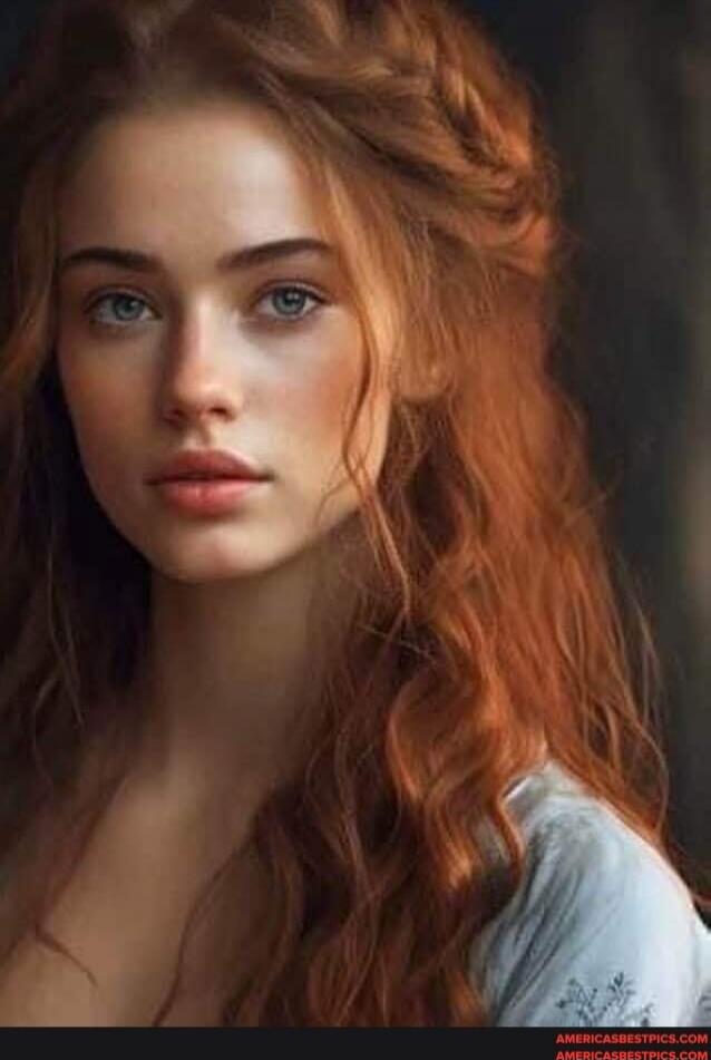 Portrait of a young woman with long red hair and blue eyes.