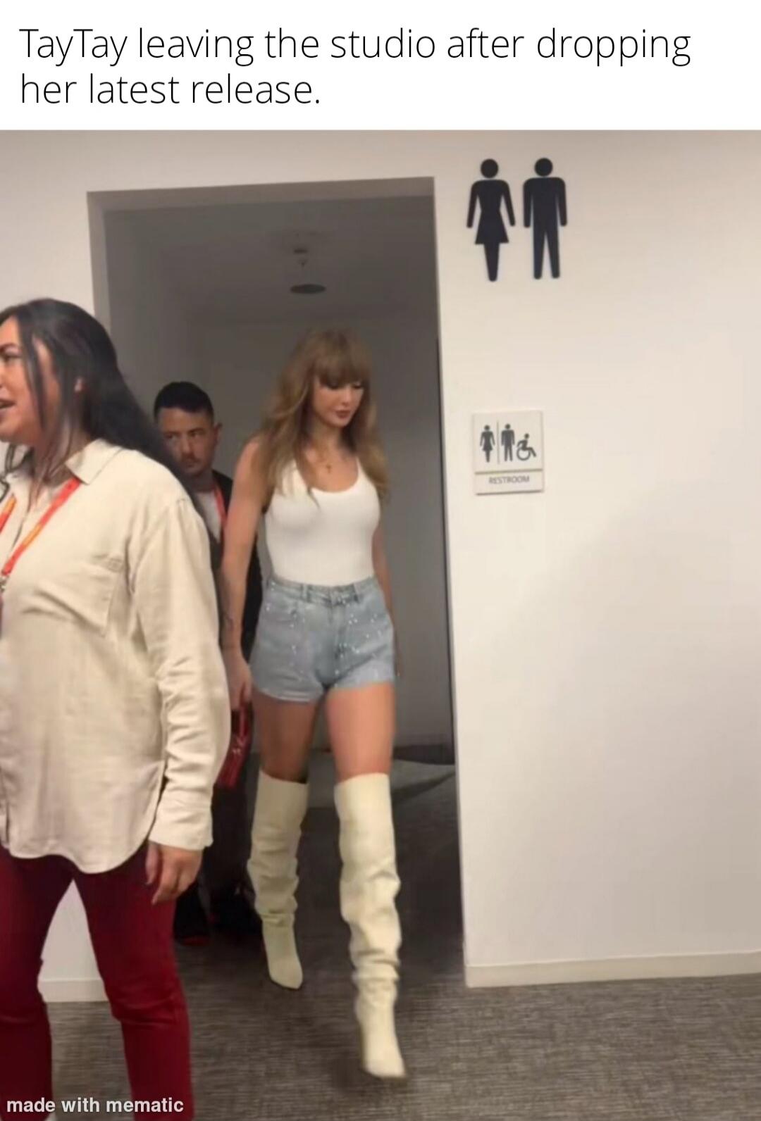 TayTay leaving the studio after dropping her latest release. Restroom sign visible on the wall.