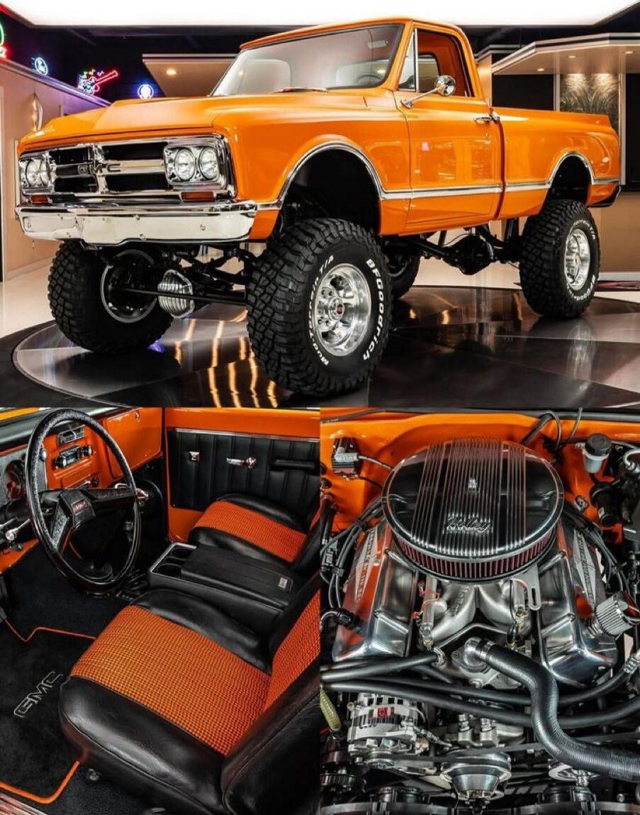 Orange lifted classic pickup truck with large off-road tires, chrome bumper, and a bold orange-and-black interior showcasing a high-performance engine.