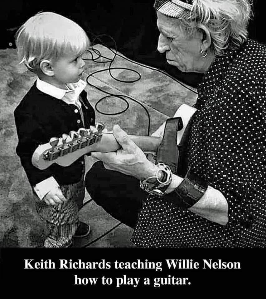 Keith Richards teaching Willie Nelson how to play a guitar