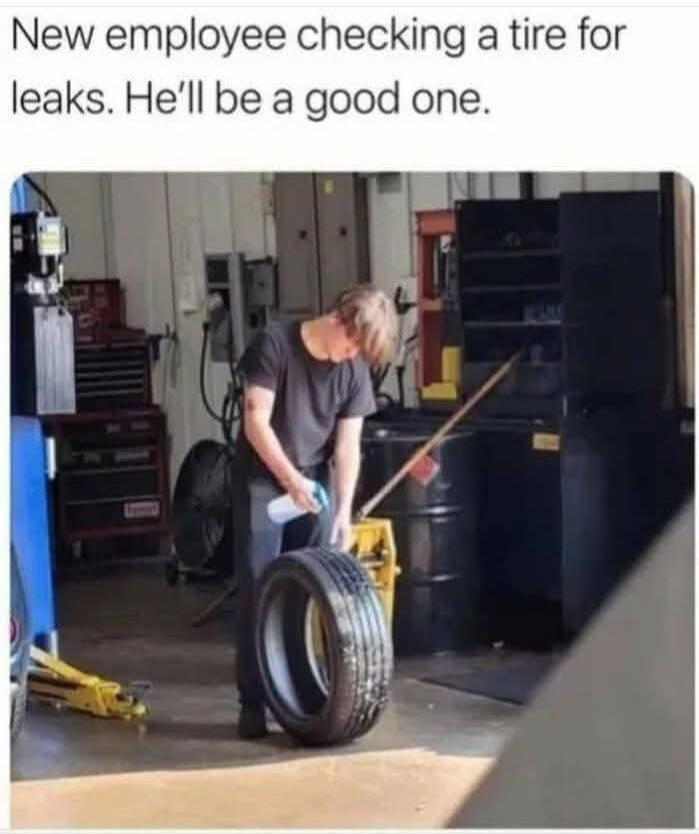 New employee checking a tire for leaks. He'll be a good one.