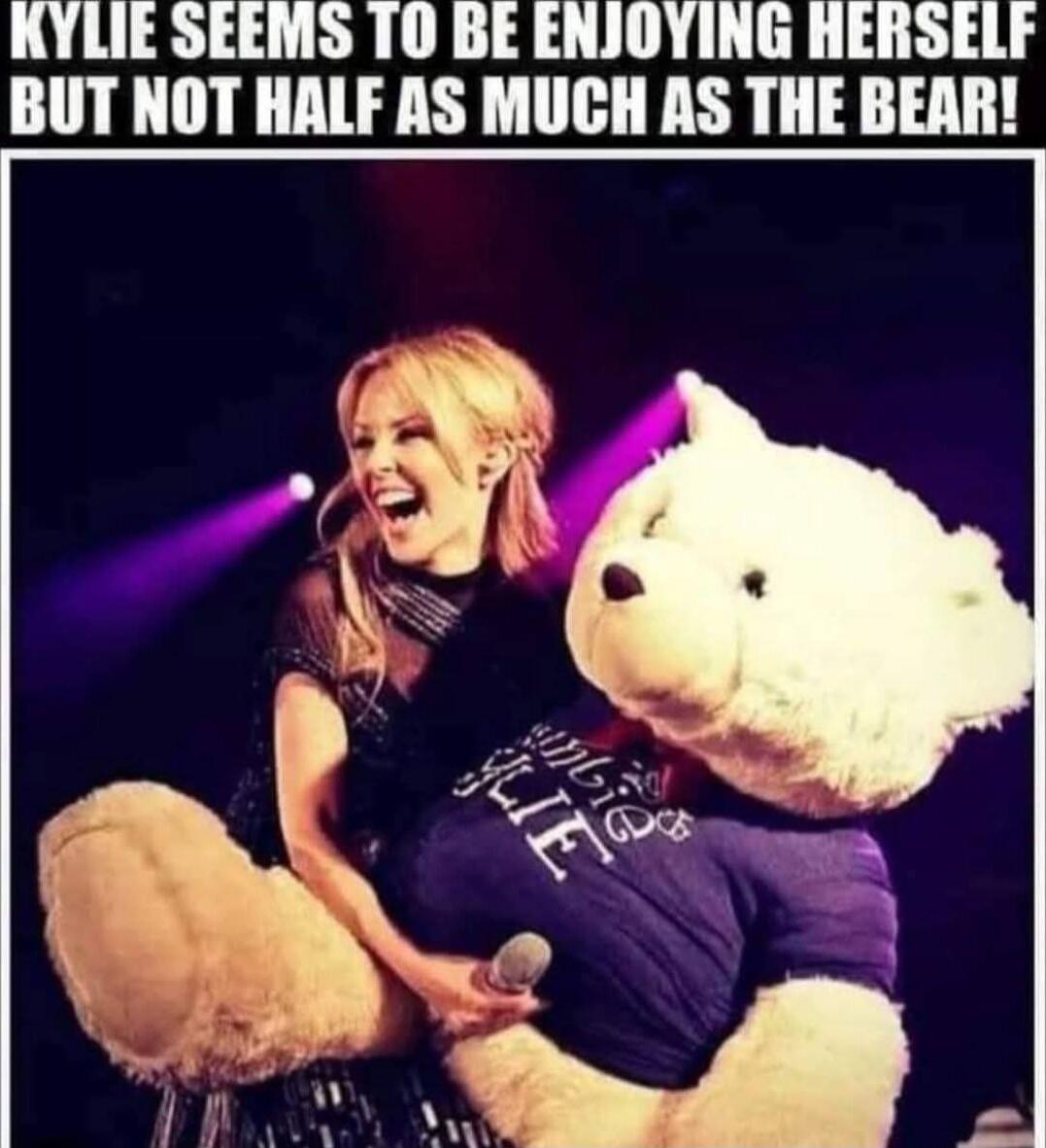 KYLIE SEEMS TO BE ENJOYING HERSELF BUT NOT HALF AS MUCH AS THE BEAR!