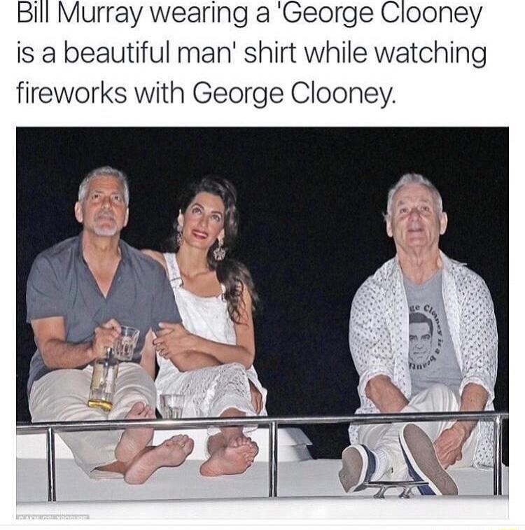 Bill Murray wearing a George Clooney is a beautiful man shirt while watching fireworks with George Clooney