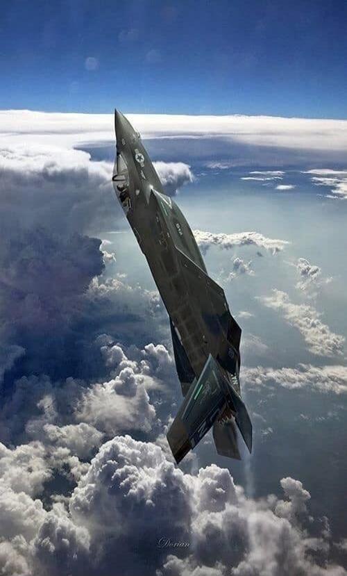 Fighter jet in the sky above the clouds.
