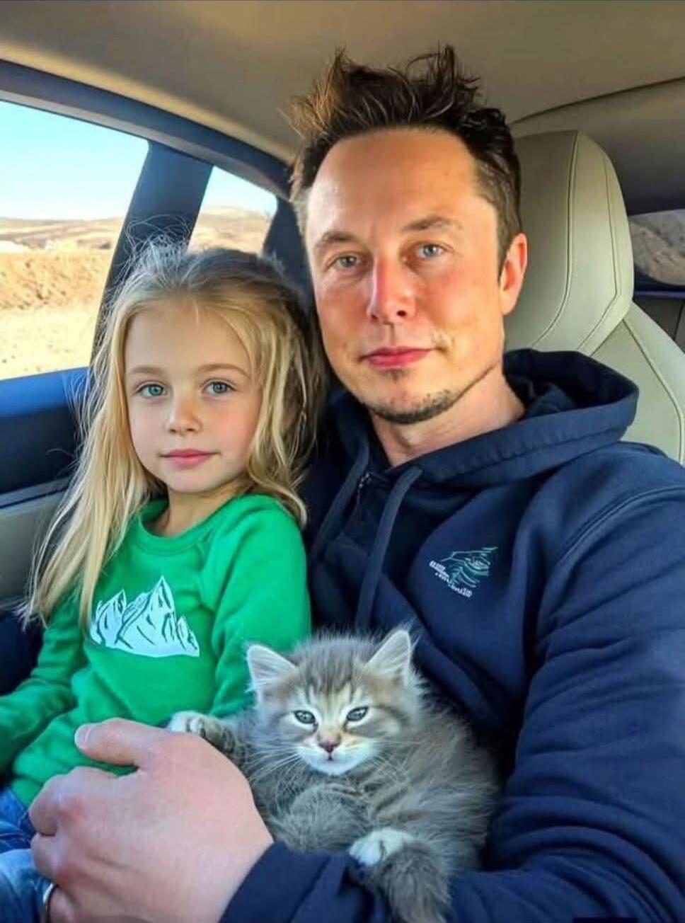 A man and a young girl sit in a car, holding a fluffy gray kitten, looking at the camera. A scenic landscape is visible outside the window.