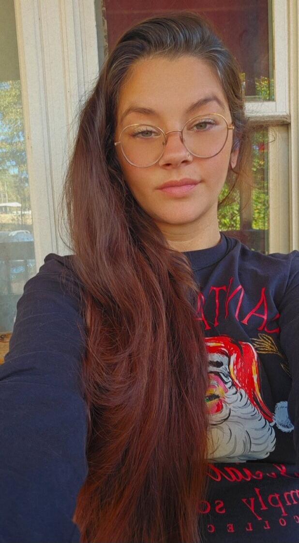 Partial text on shirt: SANTA, COFFEE