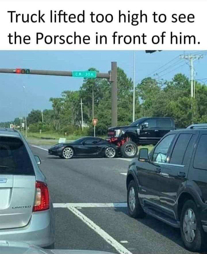 Truck lifted too high to see the Porsche in front of him A