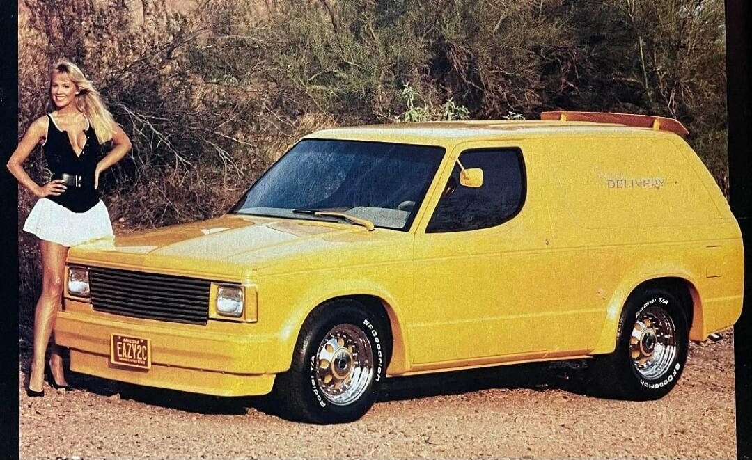A yellow van parked outdoors with a woman standing beside it.