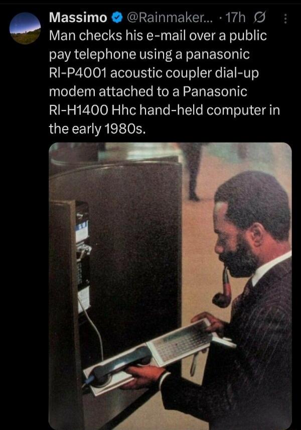 Man checks his e-mail over a public pay telephone using a panasonic RI-P4001 acoustic coupler dial-up modem attached to a Panasonic RI-H1400 Hhc hand-held computer in the early 1980s.