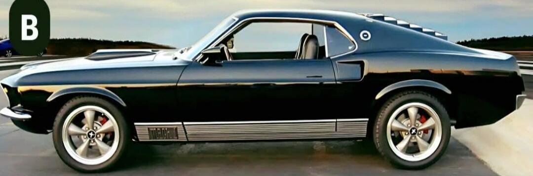 A classic black Ford Mustang Mach 1, seen from the side.