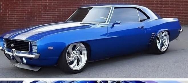 A custom blue classic car, possibly a Chevrolet Camaro, with white racing stripes on the hood. It features large chrome wheels and a lowered suspension. The letters 'LS' are visible on the front grille.