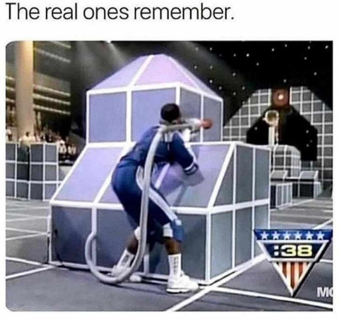 The real ones remember. A person in a blue uniform with a large hose-like attachment is playing a game in a futuristic arena with geometric structures. A scoreboard shows ':38'.