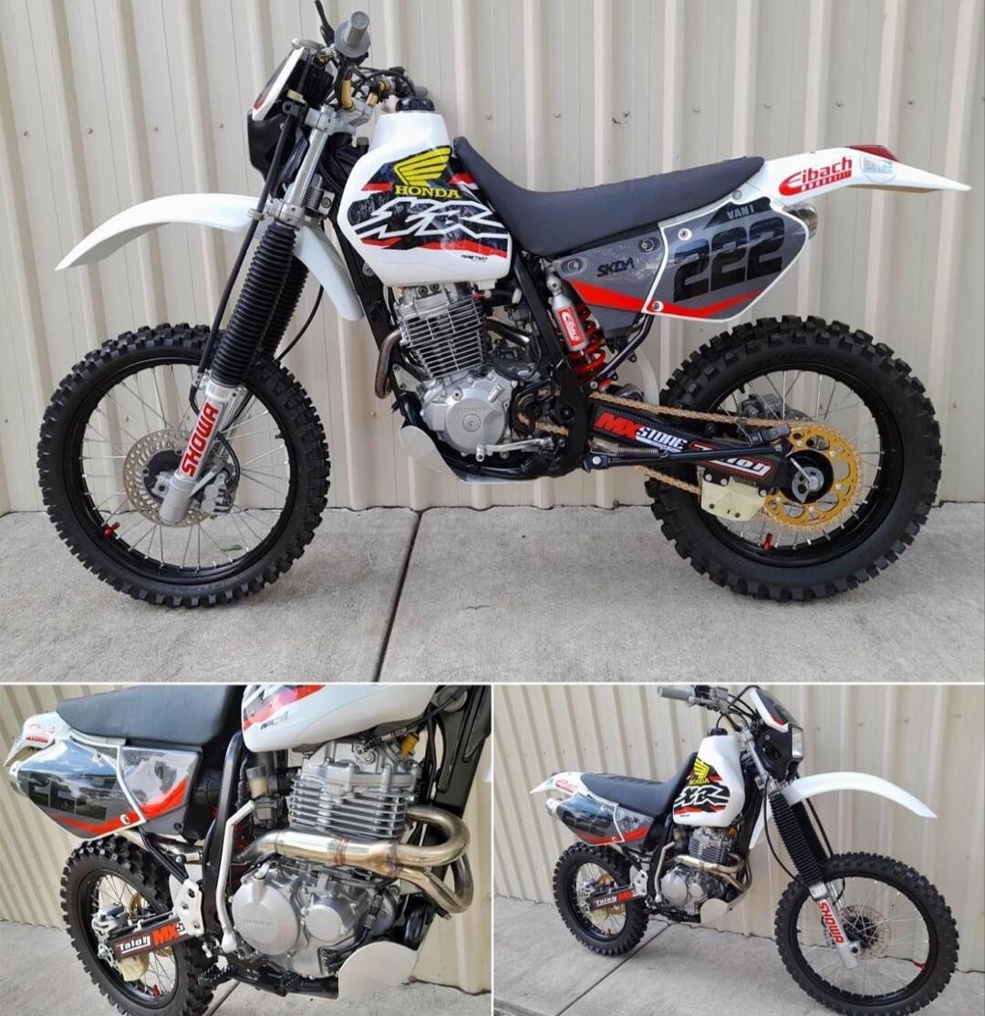 Number 22 on the side panel; 'Chad' on the rear fender. White dirt bike with black seat and red accents.