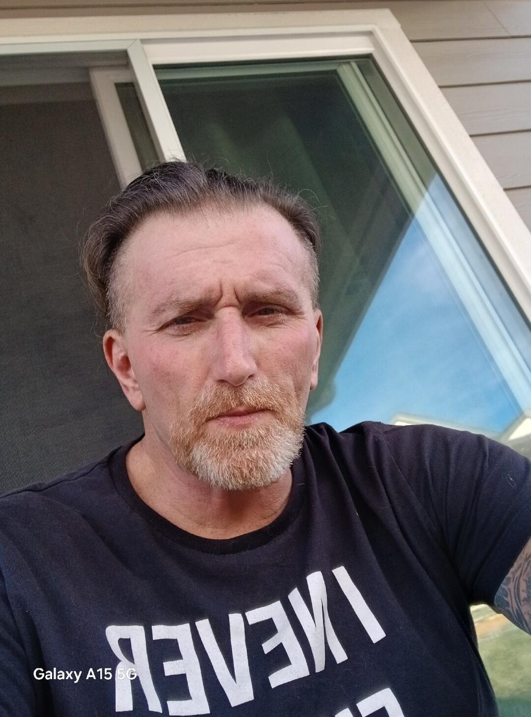 Galaxy A15 5G. The text on the t-shirt appears to be a mirrored 'NEVER'.