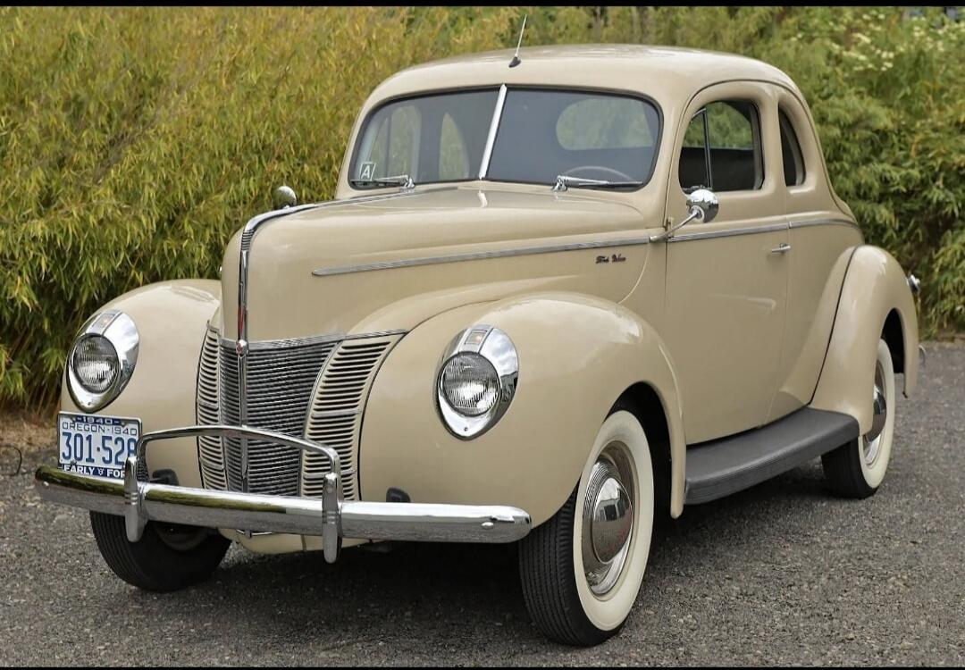 1940 Oregon license plate with number 301-528. The car is a Ford Deluxe.