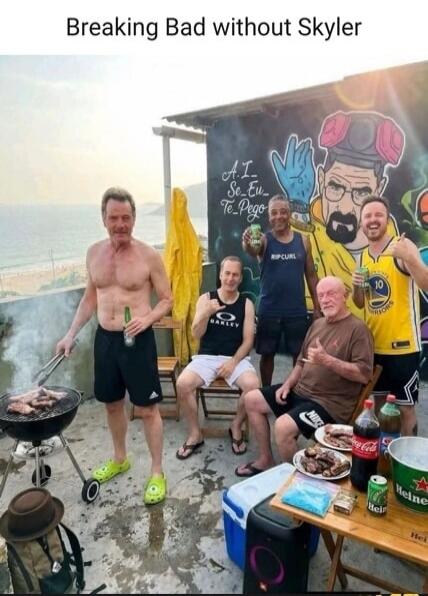 Breaking Bad without Skyler. A group of men, resembling characters from the TV show Breaking Bad (Walter White, Jesse Pinkman, Mike Ehrmantraut), are having a barbecue on a patio overlooking the ocean. One man is grilling, others are holding drinks and smiling. There's a mural of a character resembling Walter White in his hazmat suit. On a table, t