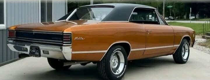 A classic Chevrolet Chevelle Malibu car, bronze with a black roof.