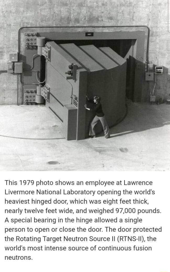 This 1979 photo shows an employee at Lawrence Livermore National Laboratory opening the worlds heaviest hinged door which was eight feet thick nearly twelve feet wide and weighed 97000 pounds A special bearing in the hinge allowed a single person to open or close the door The door protected the Rotating Target Neutron Source Il RTNS II the worlds most intense source of continuous fusion neutrons
