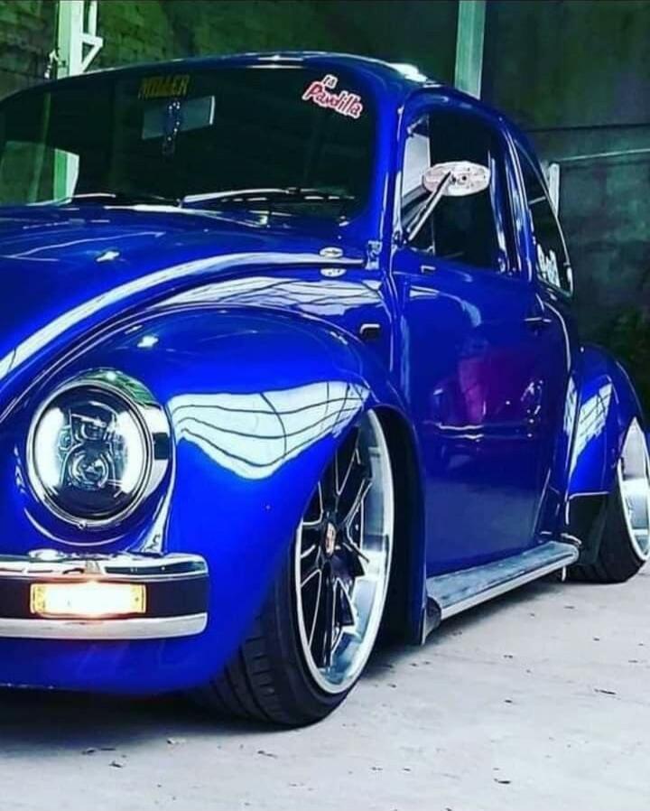 Blue vintage car with a lowered stance and large aftermarket wheels
