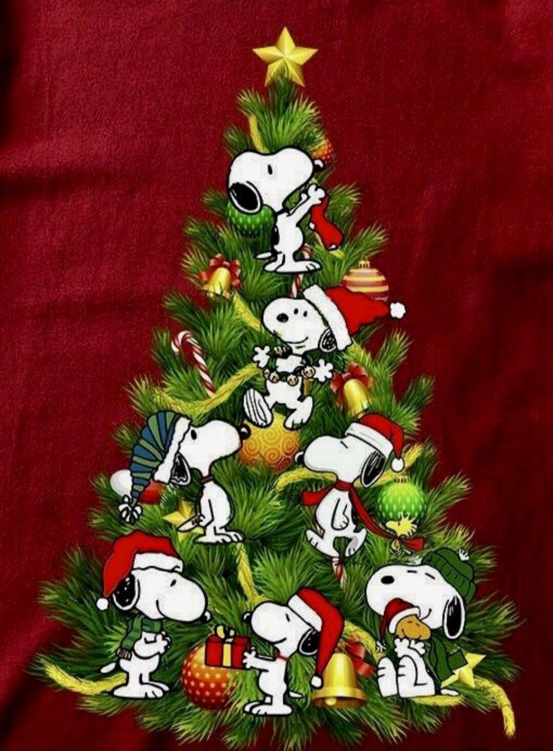 Snoopy Christmas tree with characters decorating it.