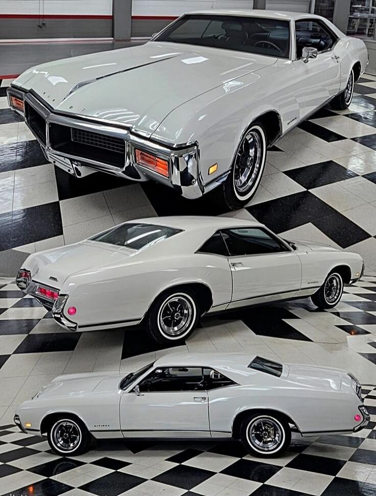 Three white classic cars displayed on a black-and-white checkered showroom floor.