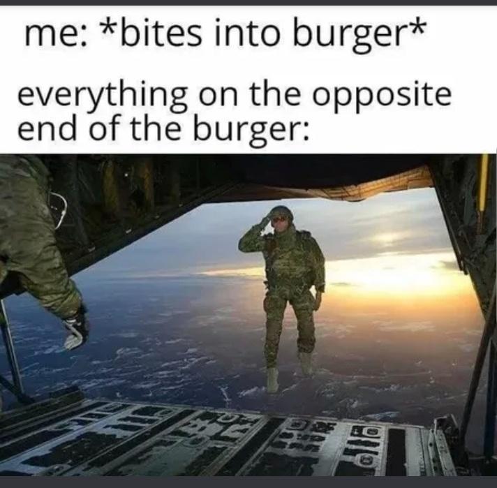 me bites into burger everything on the opposite end of the burger