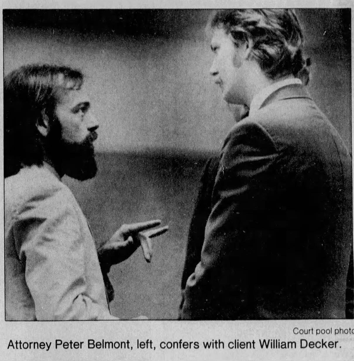 Attorney Peter Belmont left confers with client William Decker