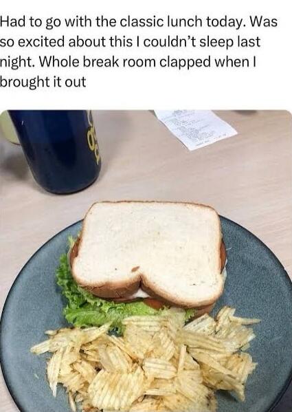 Had to go with the classic lunch today. Was so excited about this I couldn't sleep last night. Whole break room clapped when I brought it out. The image shows a simple sandwich with lettuce and tomato, accompanied by a pile of potato chips, on a plate. A blue cup and a receipt are visible in the background.