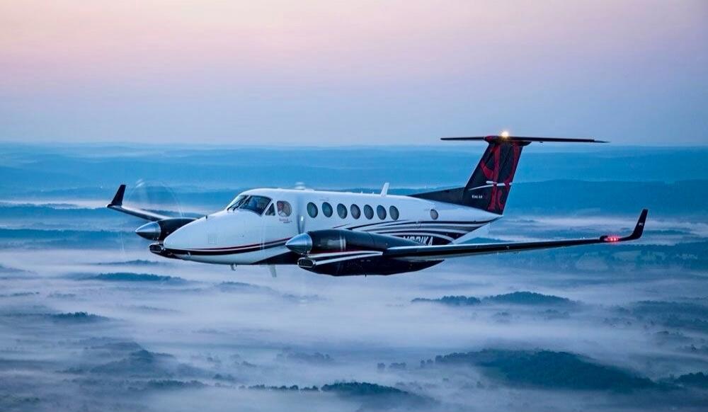 Private jet flying above the clouds.