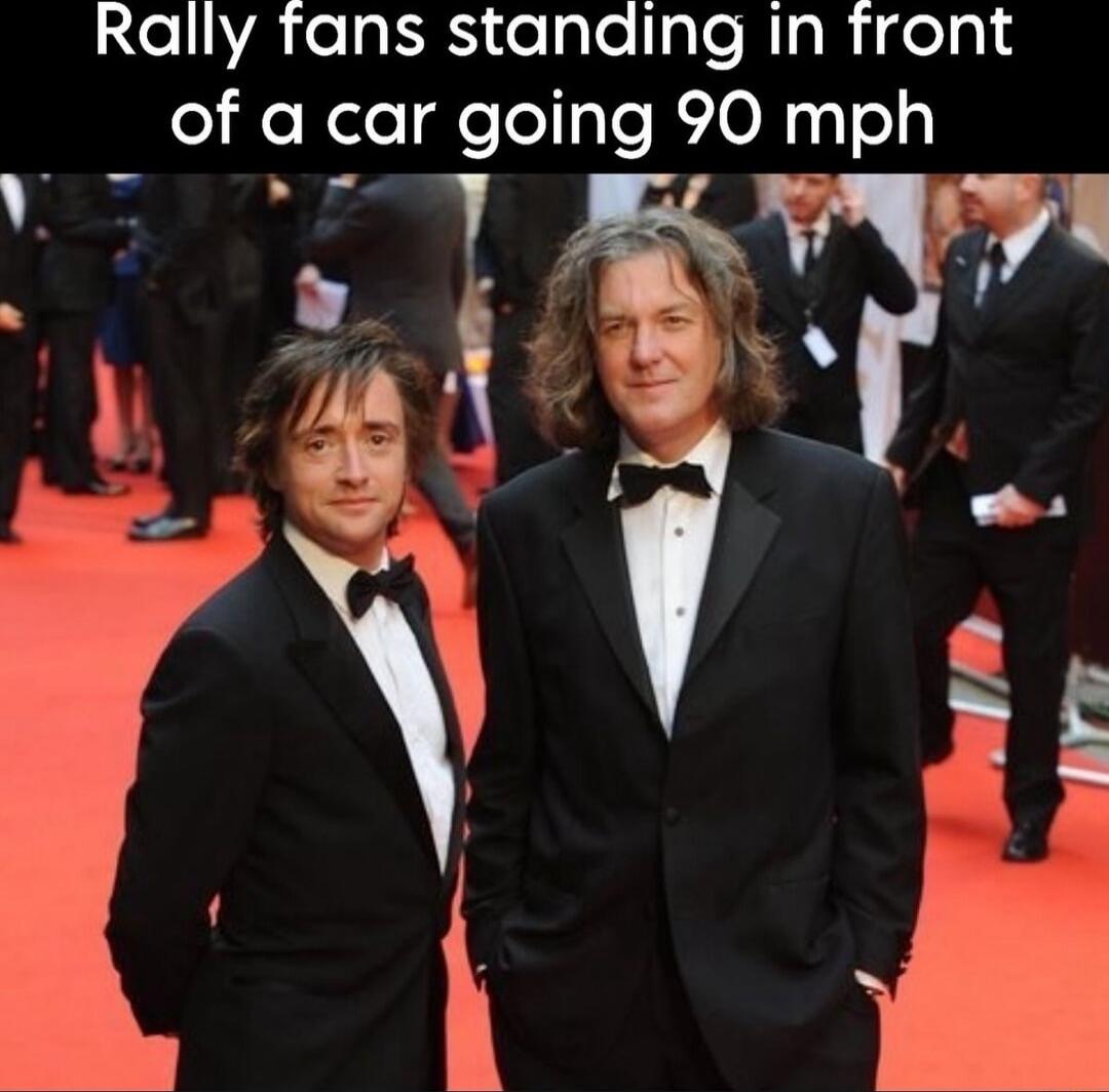 Rally fans standing in front of a car going 90 mph