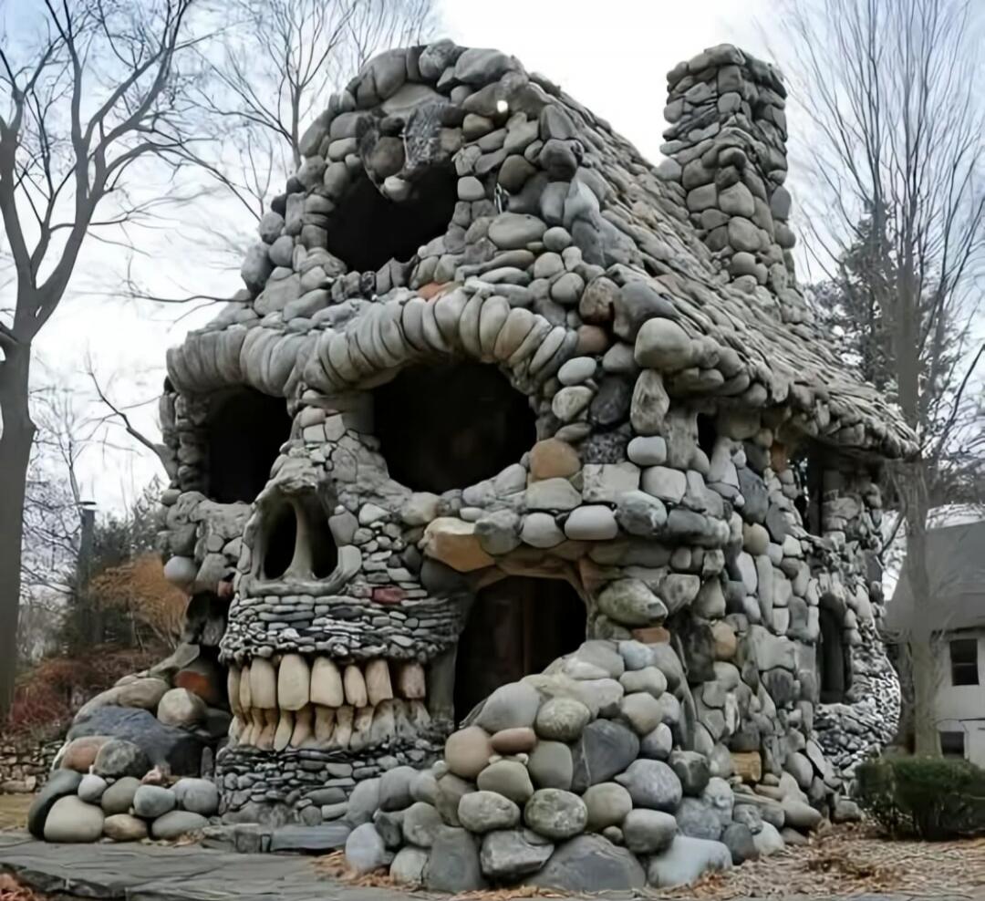 Stone skull-shaped house made of rocks.
