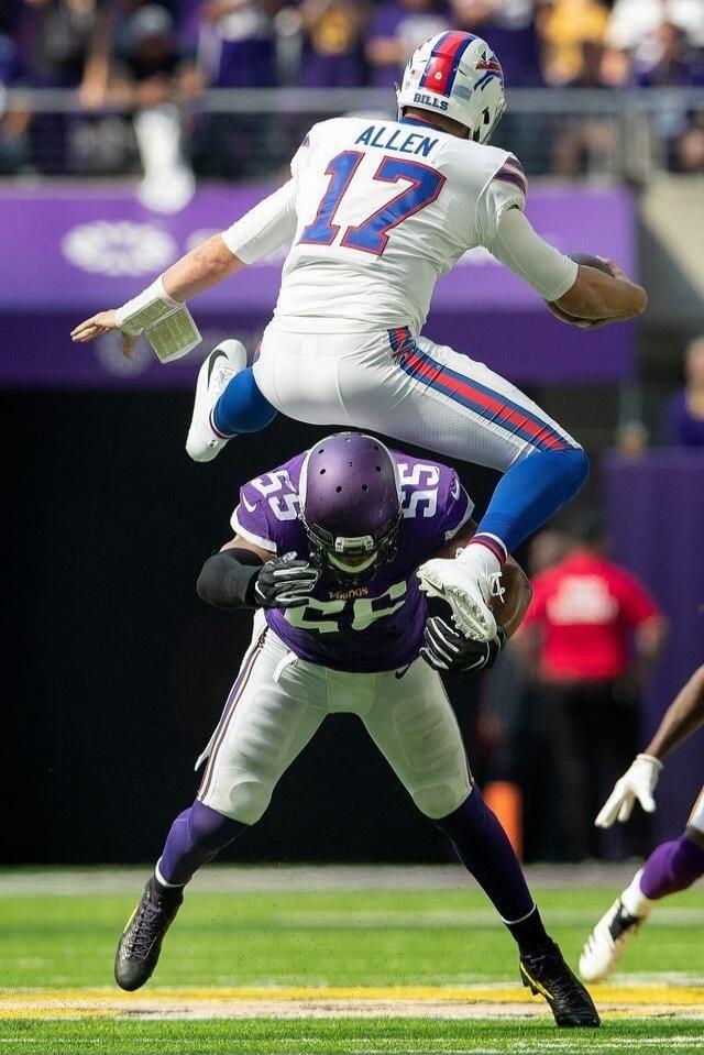 Josh Allen leaps over a defender during the Bills' game against the Vikings.