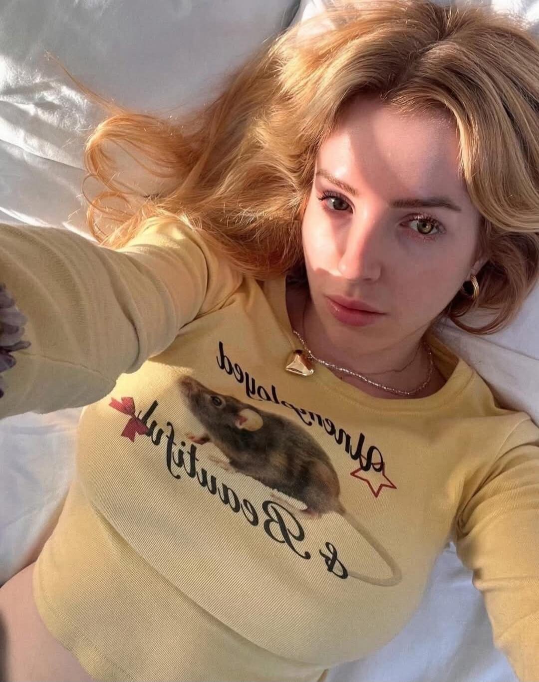 A yellow shirt with a hamster graphic and cursive text.