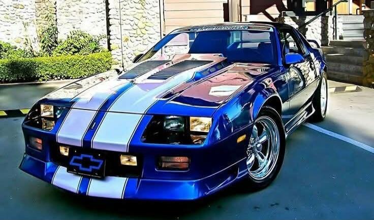 Blue sports car with white racing stripes.