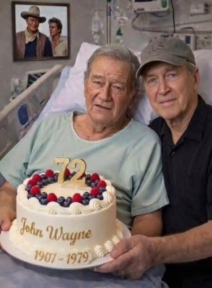 An elderly man, resembling John Wayne, is in a hospital bed, holding a cake with '72', 'John Wayne', and '1907 - 1979' written on it. Another man is beside him. A framed picture of John Wayne is on the wall.
