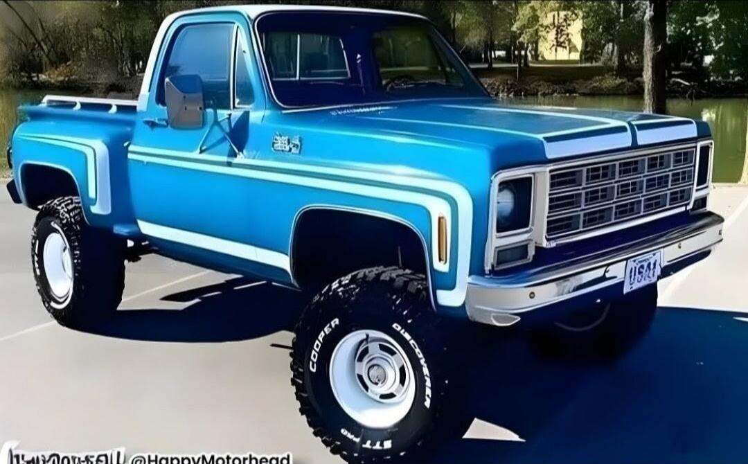 Blue vintage pickup truck with large off-road tires.