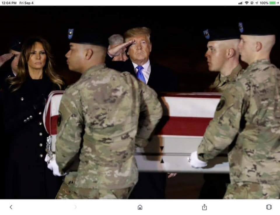 Donald Trump and Melania Trump attend a solemn military ceremony, with Trump saluting as uniformed soldiers carry a flag-draped coffin.