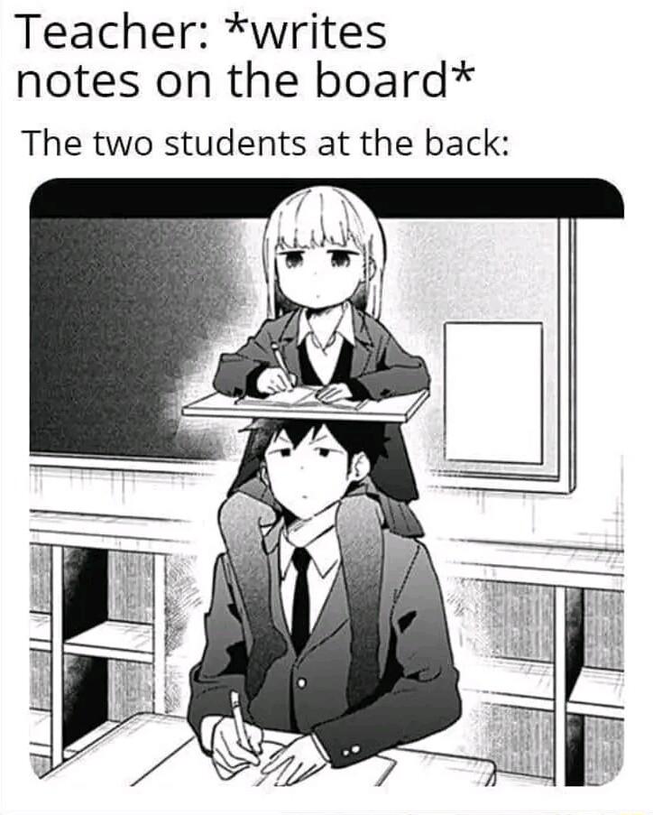Teacher writes notes on the board The two students at the back