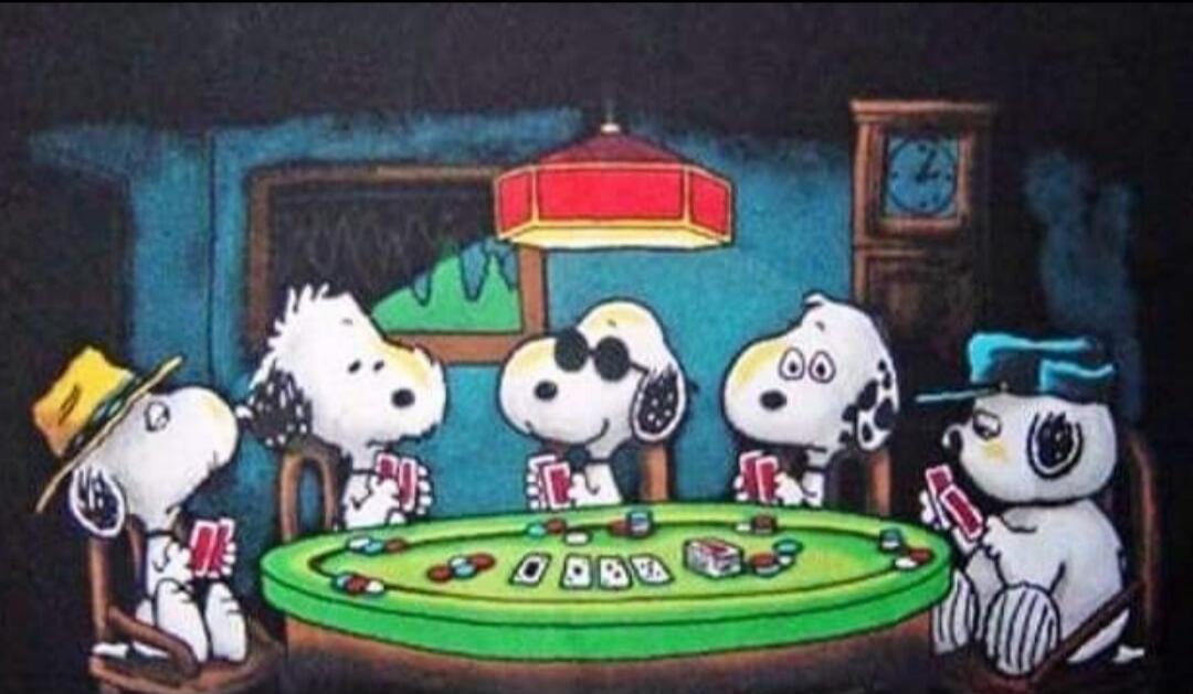 Five Peanuts characters (Snoopy and friends) sit around a green card table, playing cards under a hanging lamp in a cozy room.