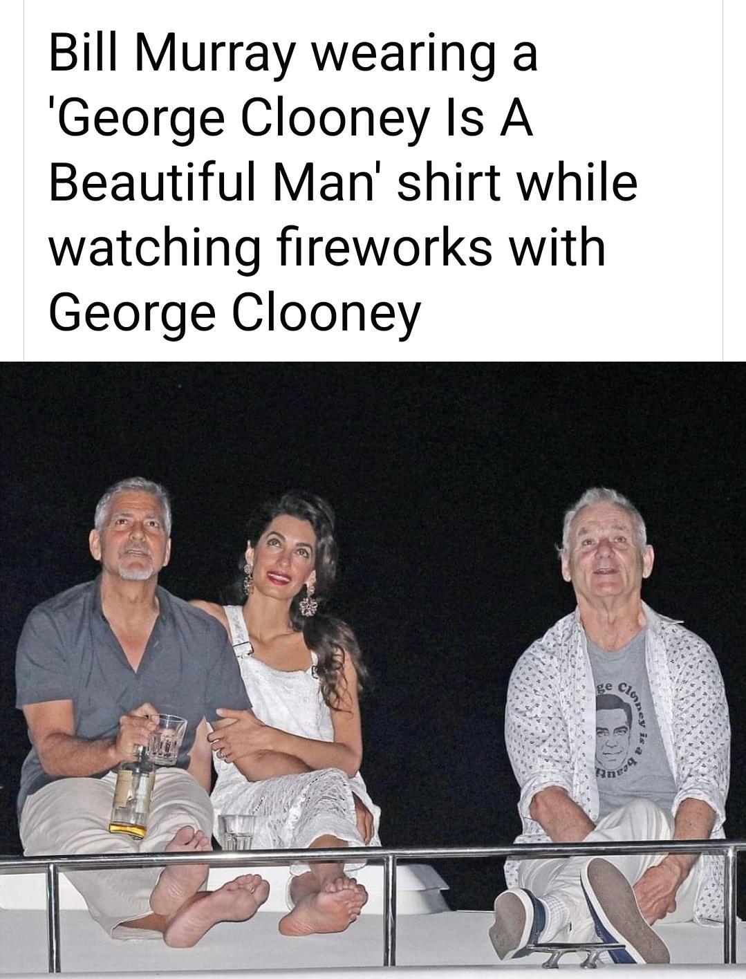 Bill Murray wearing a George Clooney Is A Beautiful Man shirt while watching fireworks with George Clooney