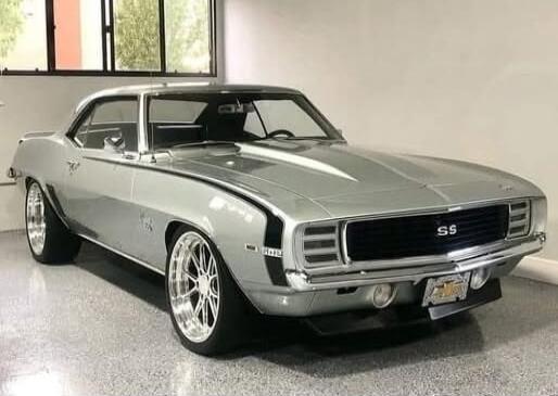 Classic silver Chevrolet Chevelle SS muscle car in a showroom.