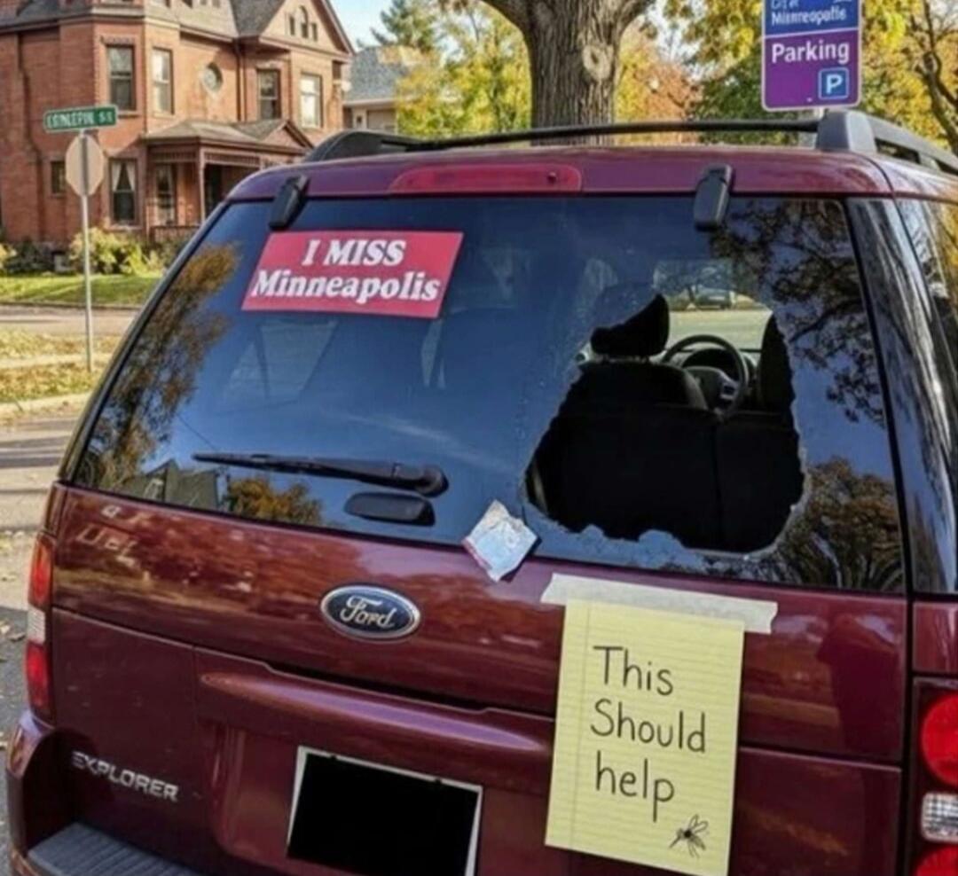 A red sticker on the rear window of a car reads 