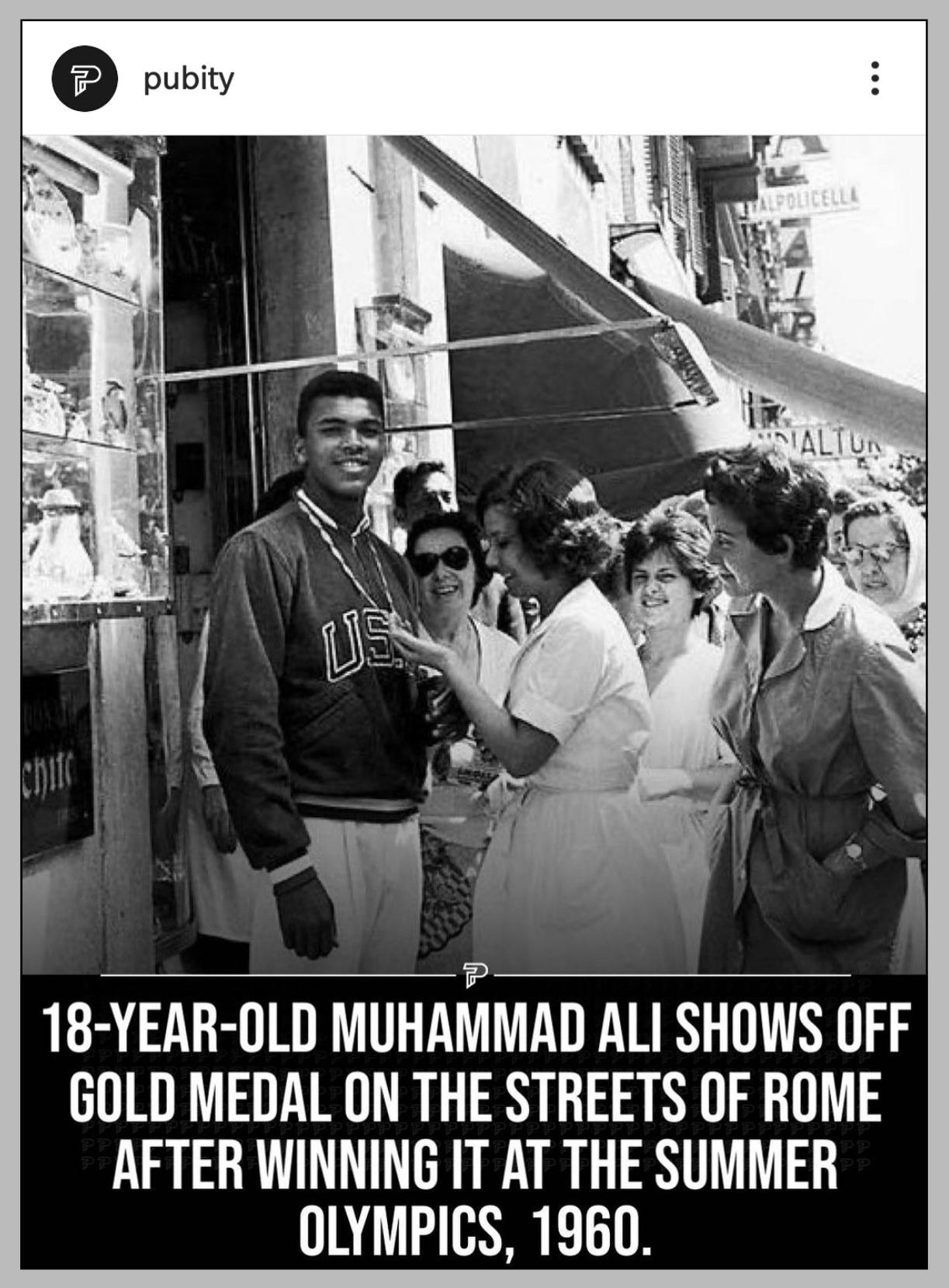 18 YEAR OLD MUHAMMAD ALI SHOWS OFF GOLD MEDAL ON THE STREETS OF ROME AFTER WINNING IT AT THE SUMMER OLYMPICS 1960