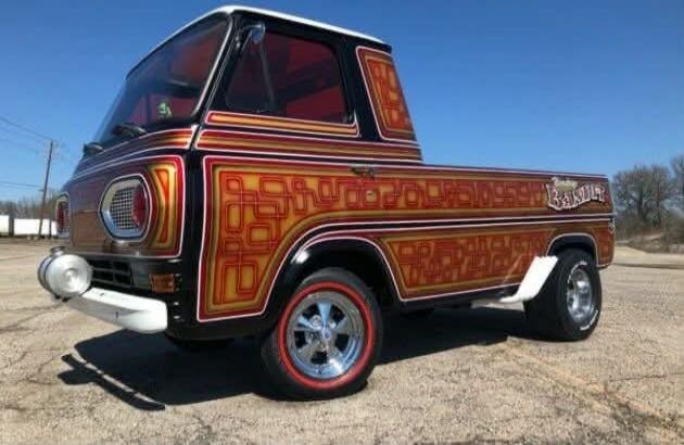 A custom vintage Ford Econoline pickup truck with a unique paint job featuring intricate pinstriping and geometric patterns. The word 'Bandit' is visible in stylized script on the side of the truck bed.
