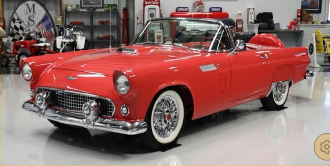 Red vintage convertible car in a showroom.
