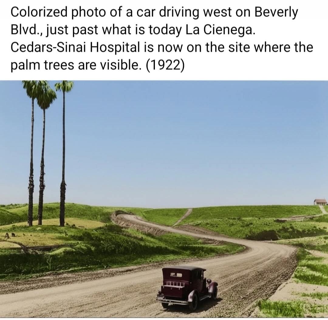 Colorized photo of a car driving west on Beverly Blvd., just past what is today La Cienega. Cedars-Sinai Hospital is now on the site where the palm trees are visible. (1922)