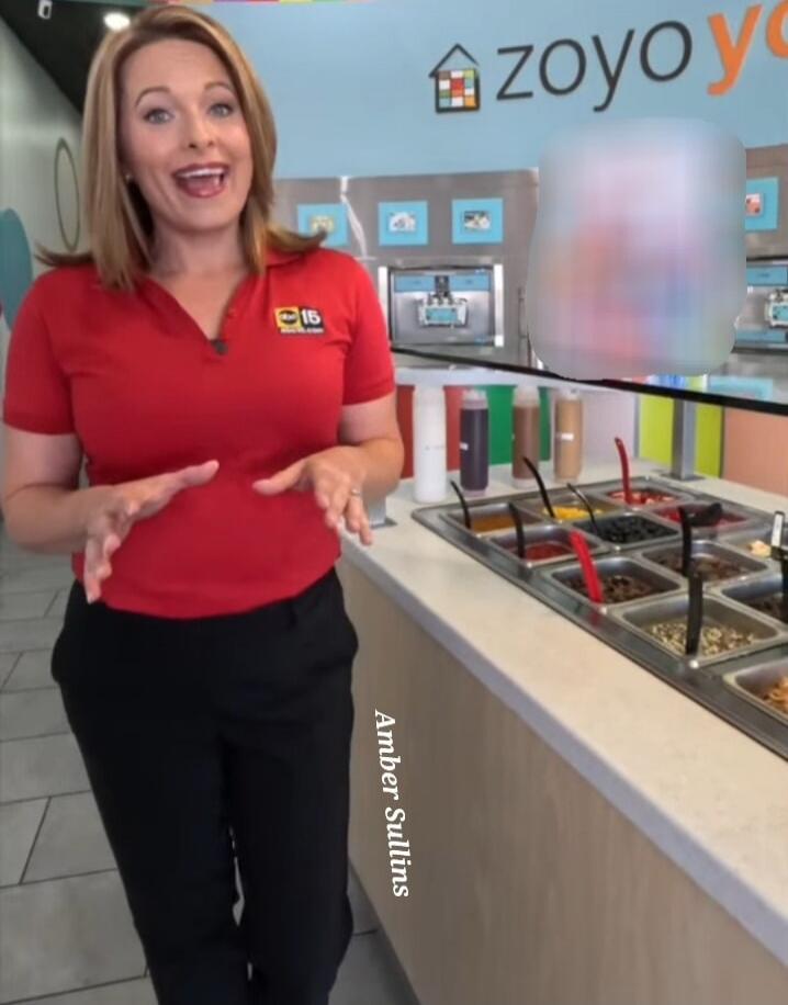 A woman in a red polo shirt and black pants stands in a Zoyo Yogurt shop, gesturing with her hands. The shop features frozen yogurt machines and a variety of toppings. Text on screen includes 'Amber Sullins' and 'zoyo yo'.