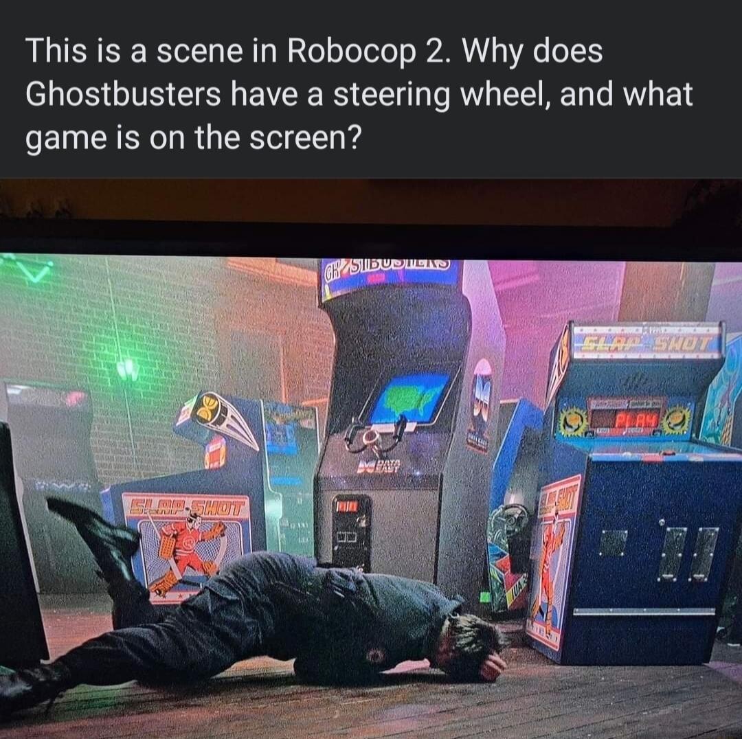 This is a scene in Robocop 2 Why does Ghostbusters have a steering wheel and what game is on the screen